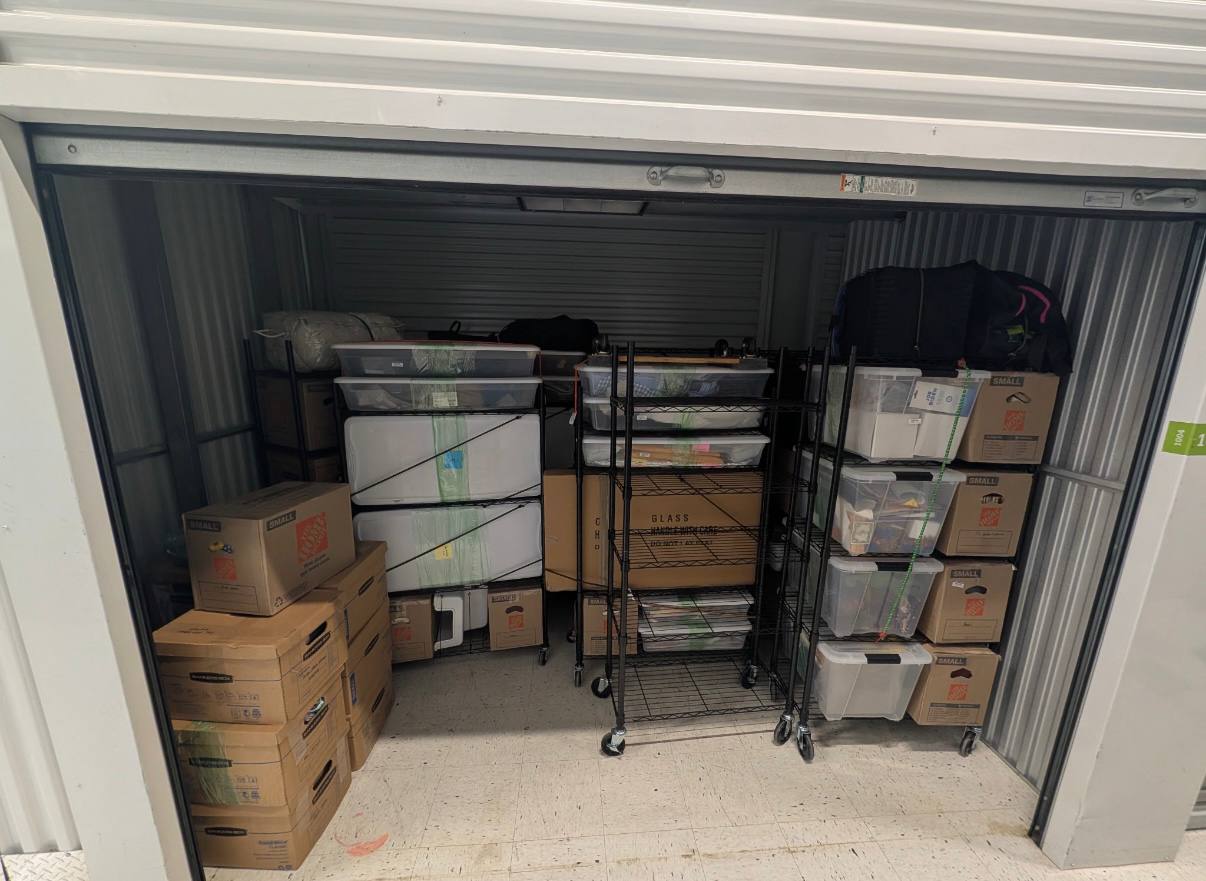 Organized storage unit with boxes and shelving units