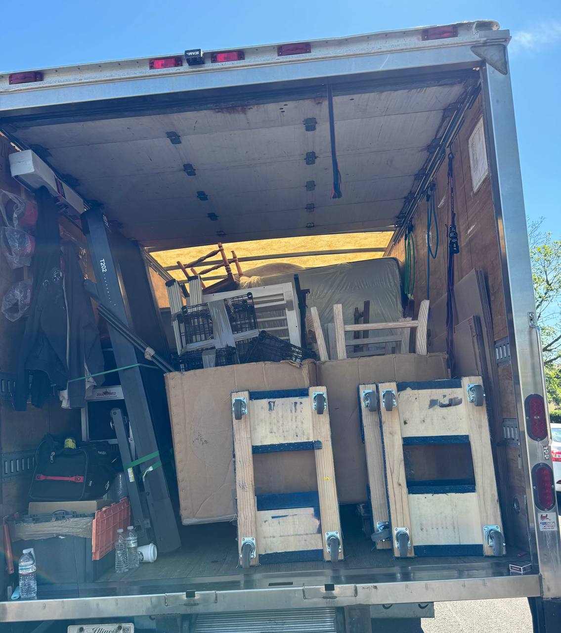 Moving truck loaded with furniture and household items for 2-bedroom apartment relocation