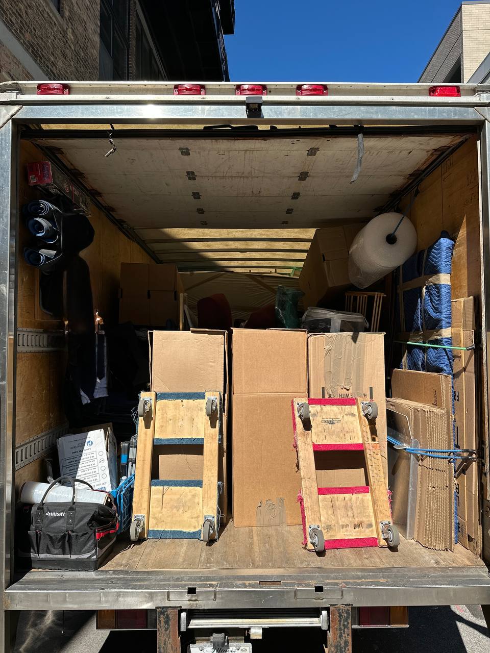 Moving truck loaded with boxes and furniture for 1-bedroom apartment relocation