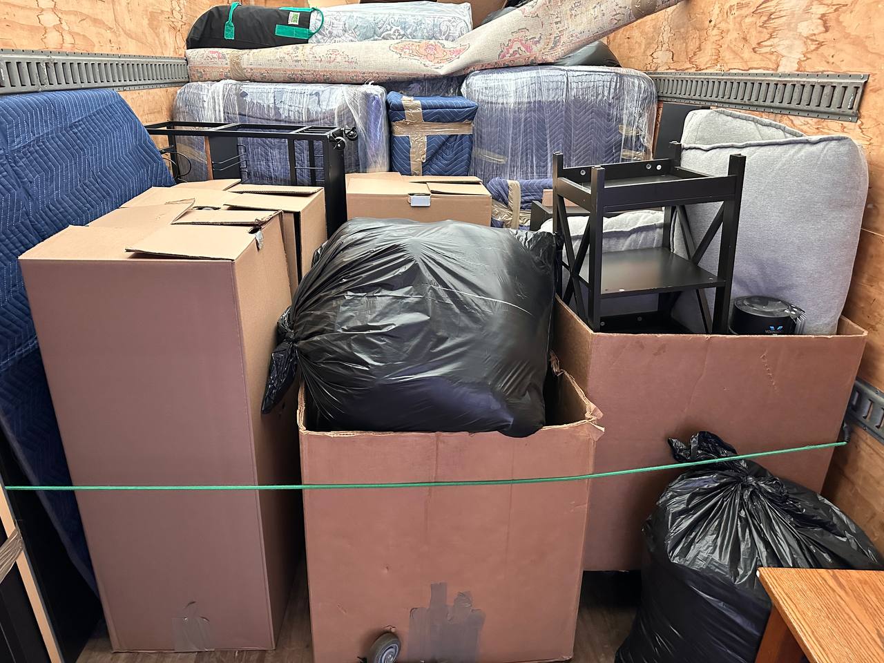Fully loaded moving truck with furniture, mattresses, boxes and household items