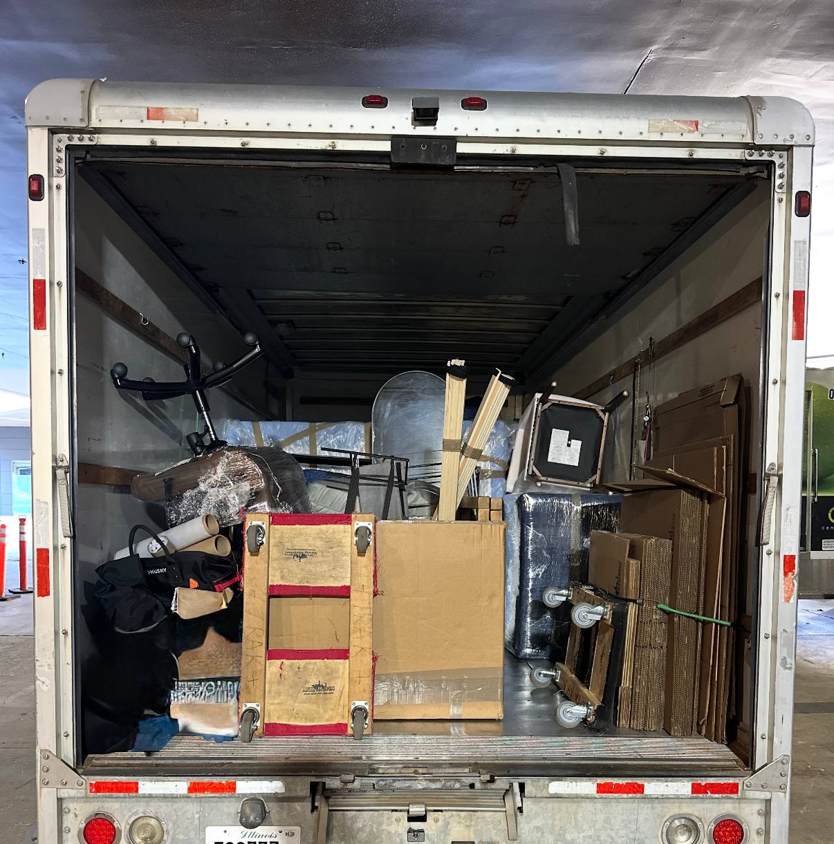 Moving truck loaded with furniture, boxes, and professional moving equipment